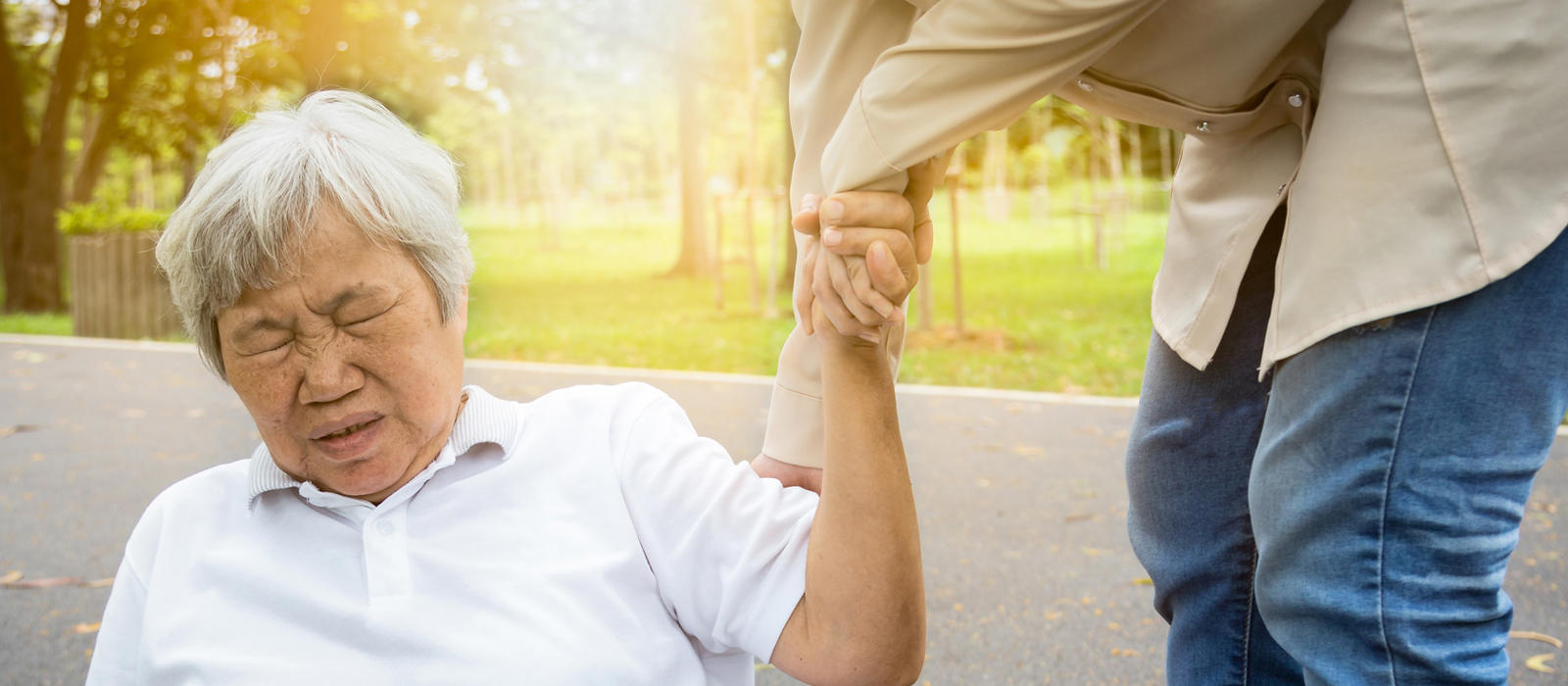 older woman being helped up